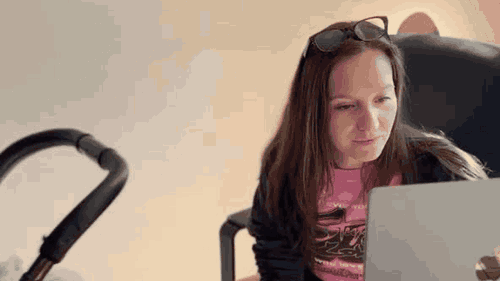 Cordelia working on the sofa with her laptop